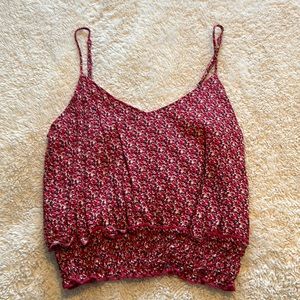 Pink floral crop top w/ adjustable straps! Also has blue and white accents.